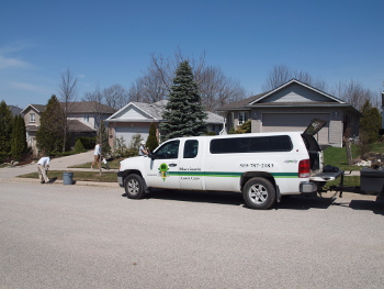 MLC company vehicle and staff working at a residence